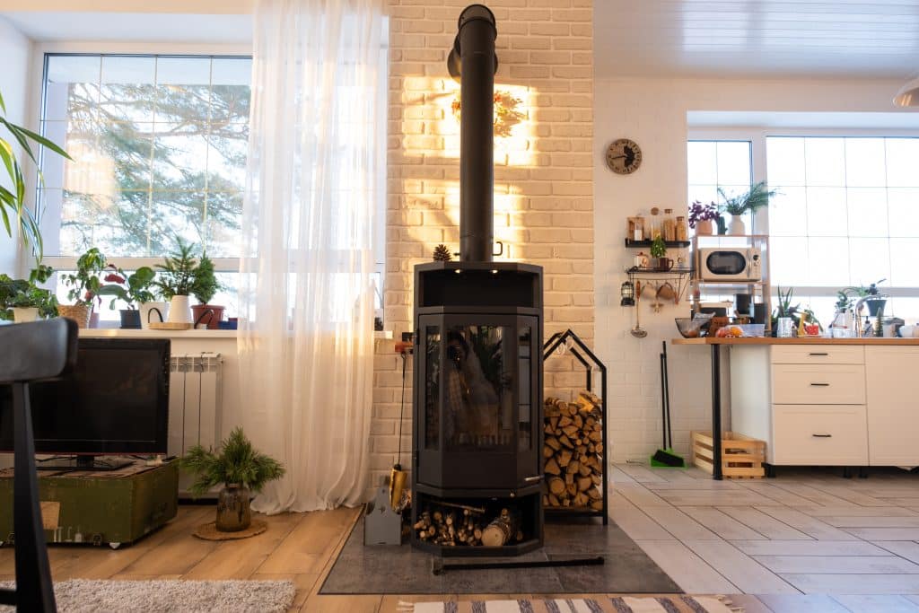 Black stove, fireplace in interior of house in loft style. Alter